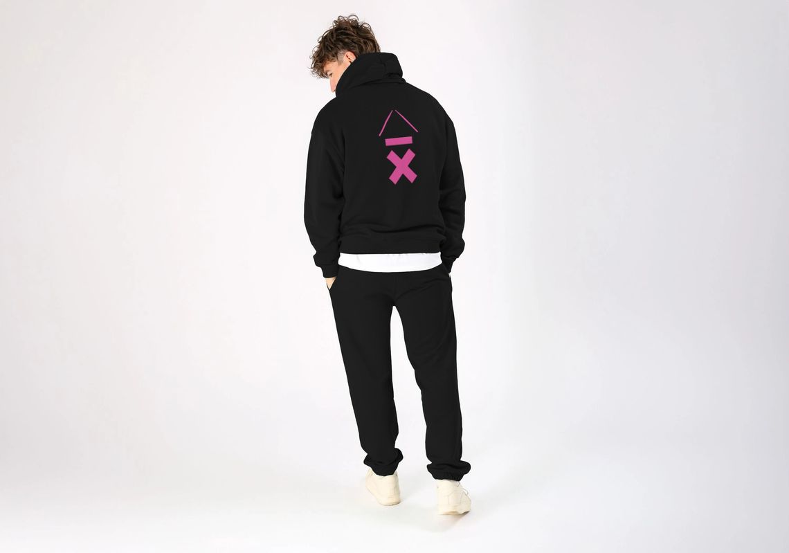 man wearing an Above Average Clothing hoodie with a bright neon pink DRMMR Ascent on the back. Vicky O'Neon's favourite design