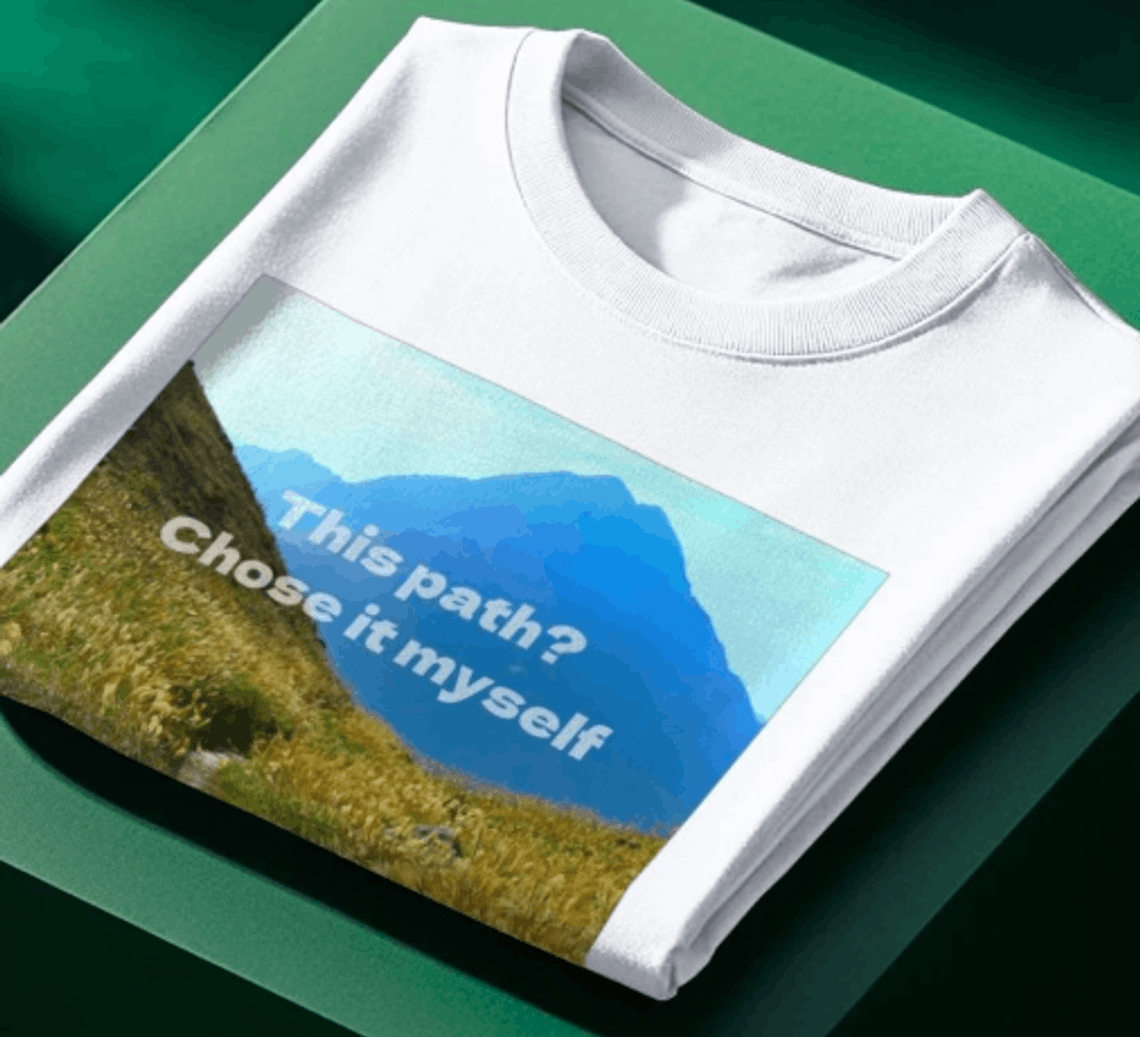 Picture of an Above Average tee with a design featuring a mountain path winding into the distance and the slogan, 'this path? Chose it myself'