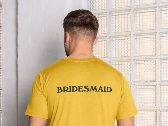 A customisable Bridesmaid T-Shirt from Branded + Moniker in white organic cotton with "Bridesmaid" printed on the back.
