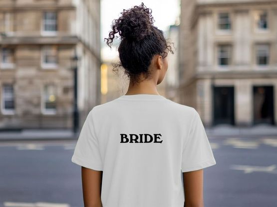 A customisable Bride T-Shirt from Branded + Moniker in white organic cotton with "Bride" printed on the back.