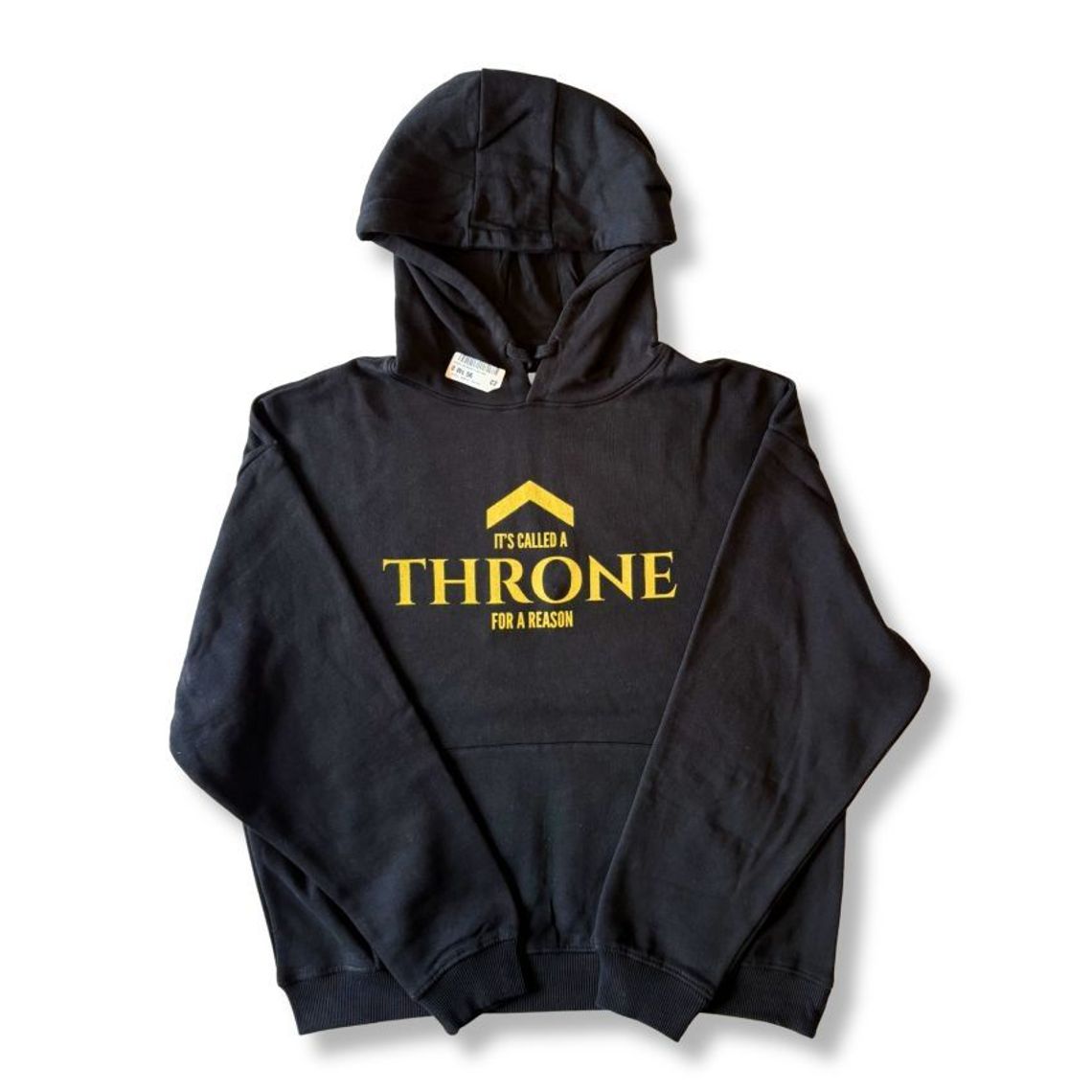 Flat lay of a black organic cotton hoodie with a gold caret ascent and THRONE-style word graphic, representing musician mindset streetwear and sustainable, circular organic cotton clothing in the UK. Above Average Clothing