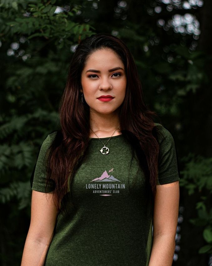 A woman wearing a dark green lord of the rings T-shirt